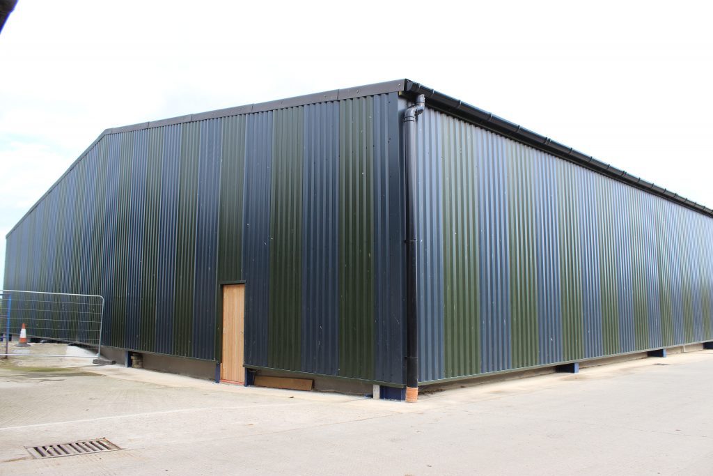 Equestrian centre with blue and green plastisol cladding erected in North Yorkshire