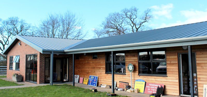 Office building clad in merlin grey composite panels with brick and timber finish