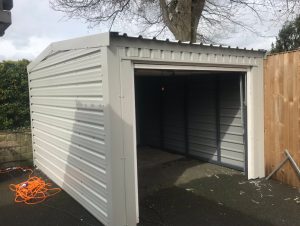Small domestic steel framed shed for a lawn tractor